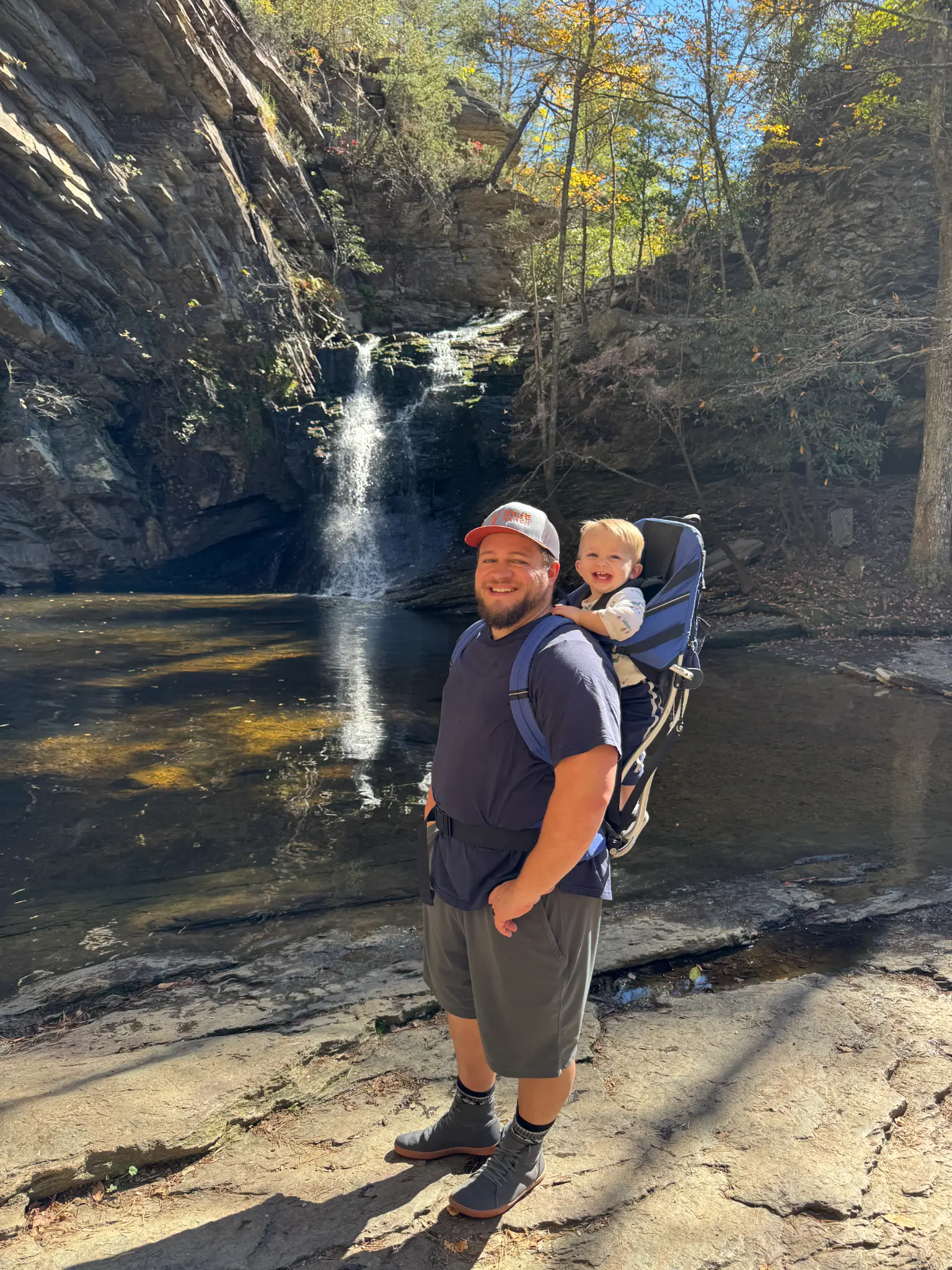 Tanner hiking at a waterfall with his son